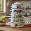 White enamel pot stacked set with floral patterns, a retro home cookware details Picture